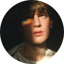 this is a small round picture or the author with a light blue boundary